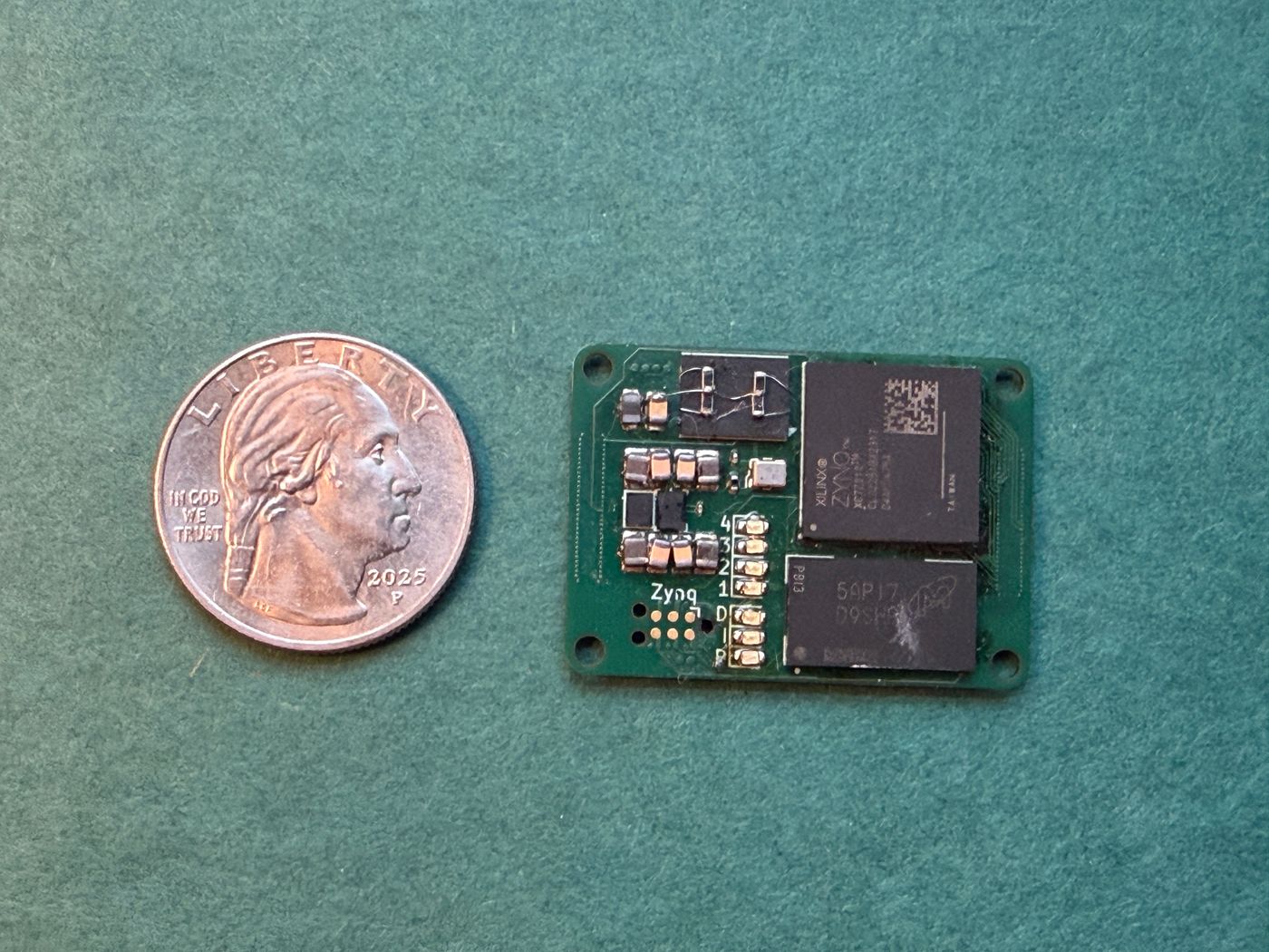 Assembled Mini Zynq board next to a coin