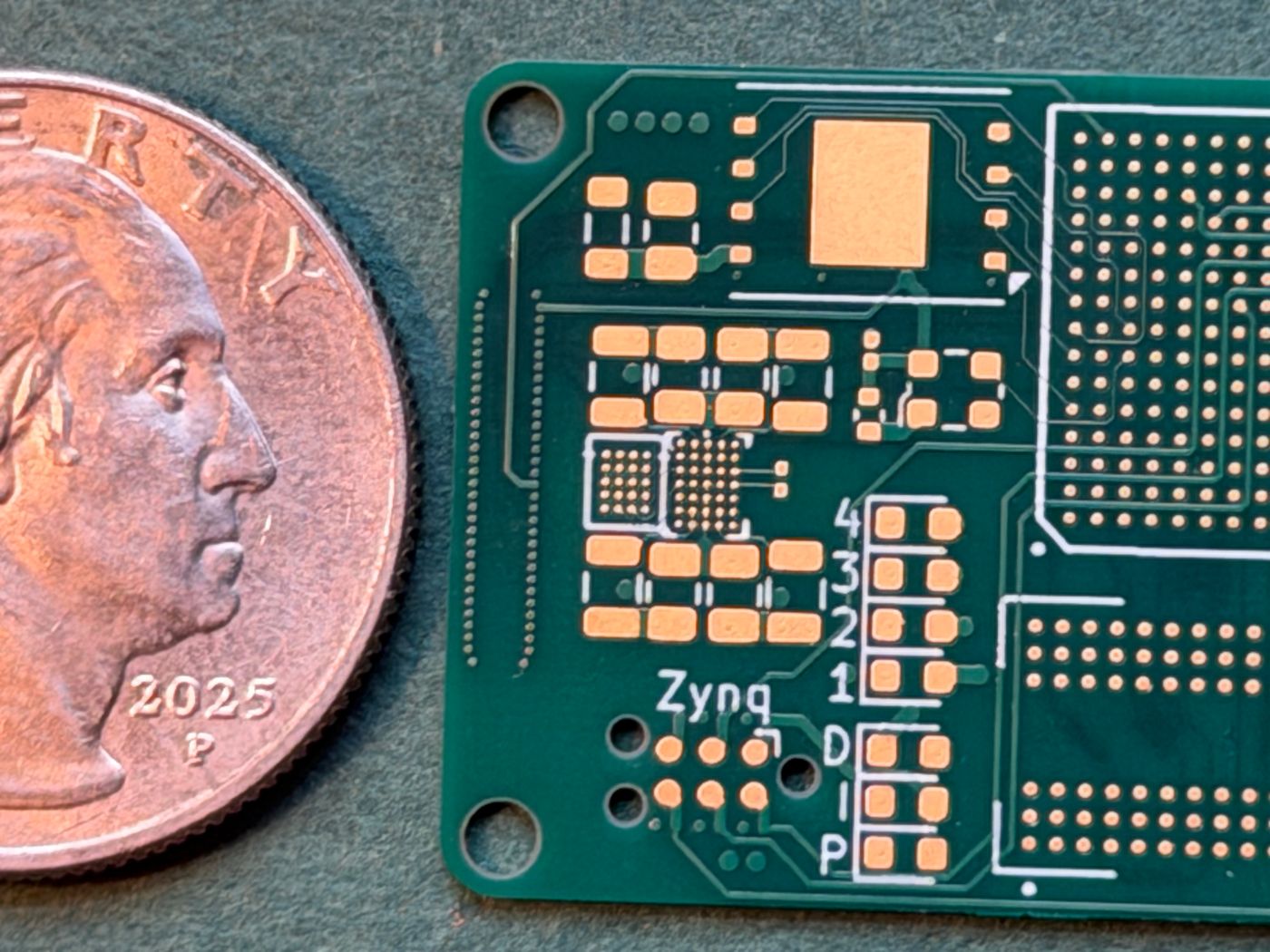 Mini Zynq board beside a coin for scale